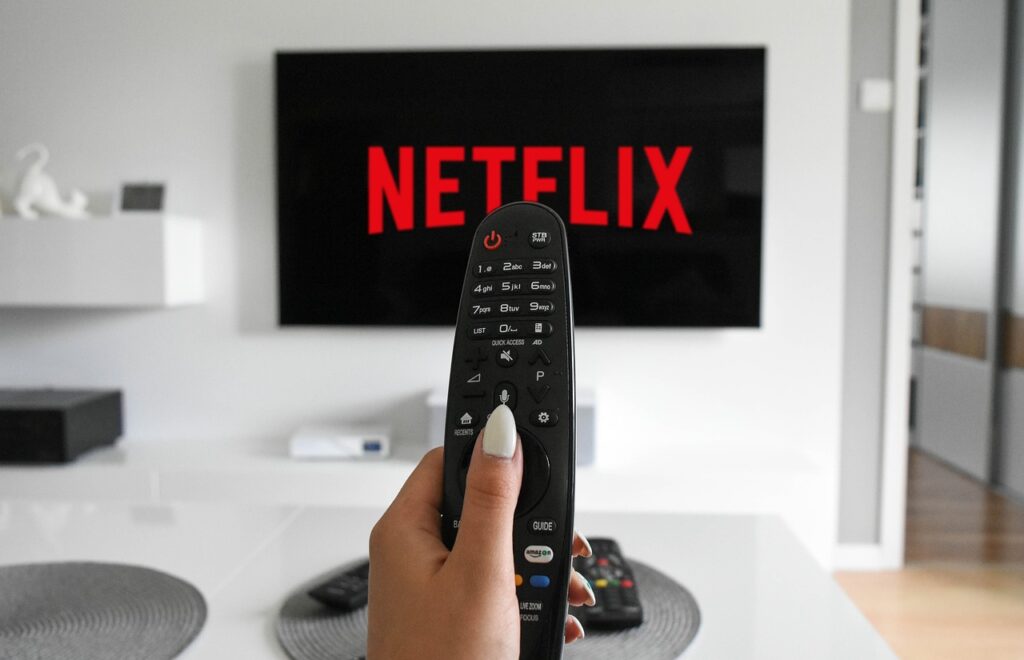 Greatest Technological Innovations Netflix Streaming Site with Remote in Hand